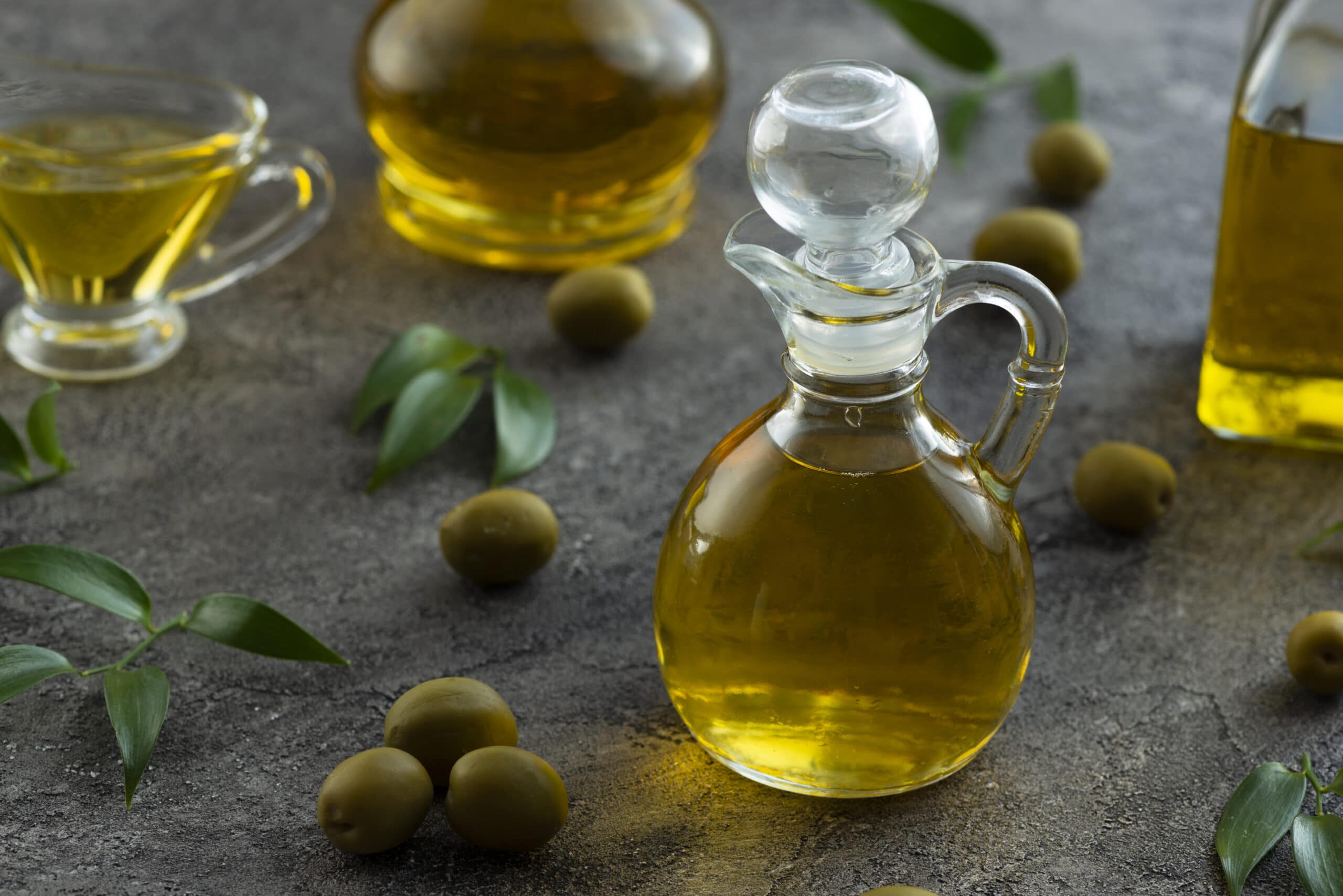 high-view-bottles-filled-with-olive-oil-marble-background(1)